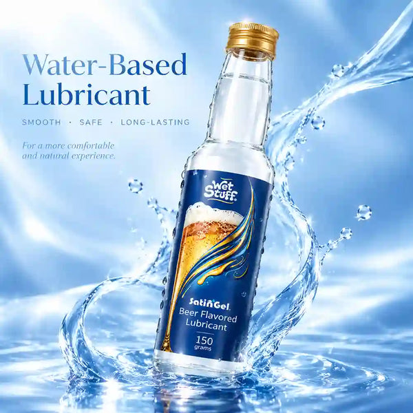 A bottle of Wet Stuff beer-flavored water-based lubricant stands in a splash of water against a blue background. The bottle has a gold cap and a dark blue label with a beer graphic and the Wet Stuff brand name.