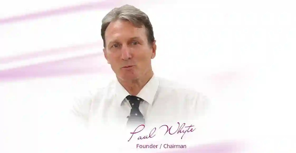 Man in a white shirt with a black tie against a light purple background the Doctor paul whyte giving introduction 