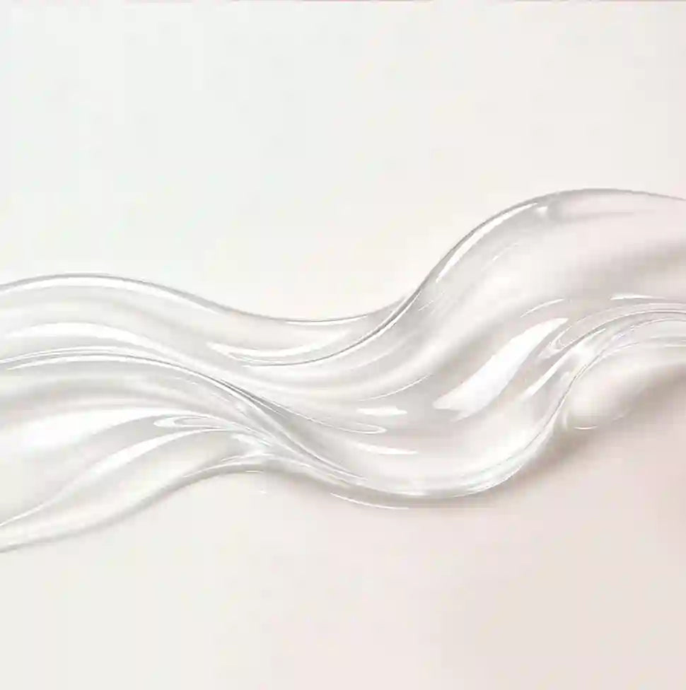 Clear, wavy glass object on a light pink background