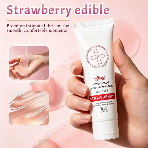 Tube of strawberry-flavored personal swallowable lubricant held by a hand with a pink background