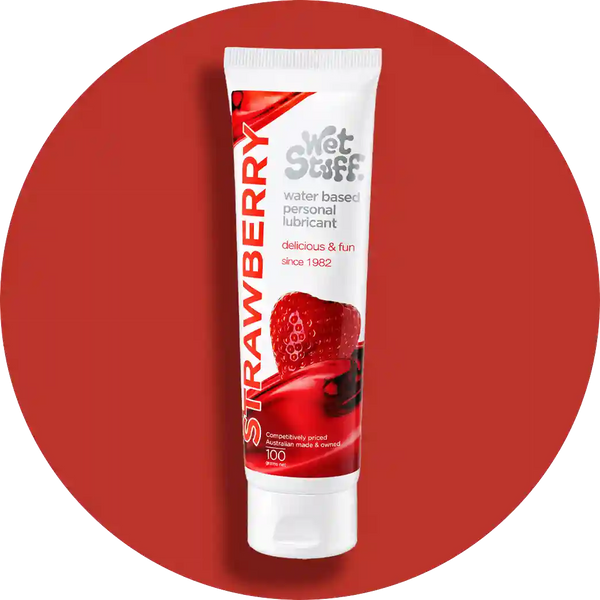 Tube of strawberry-flavored personal lubricant on a red background