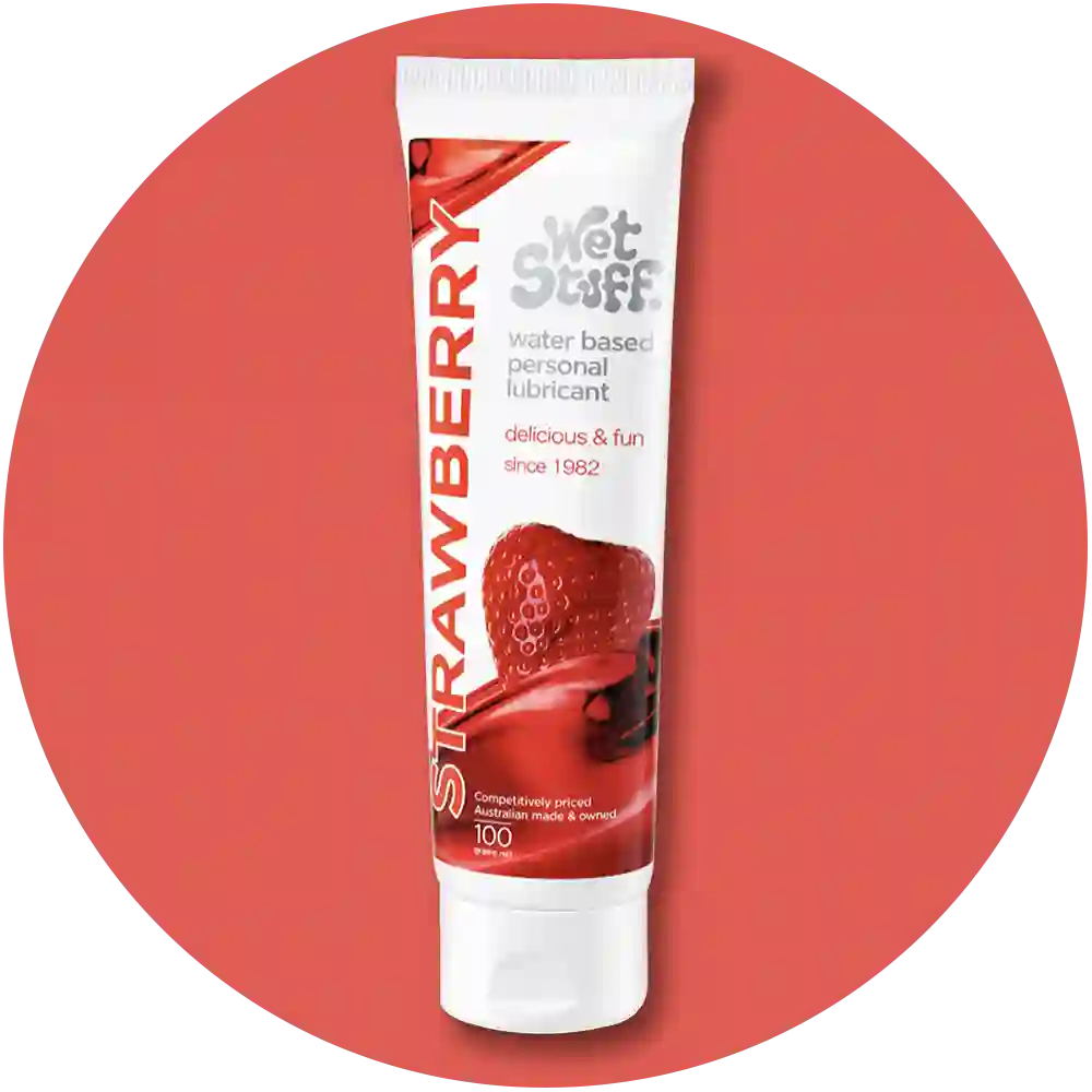 Tube of strawberry-flavored personal coupling lubricant on a white background
