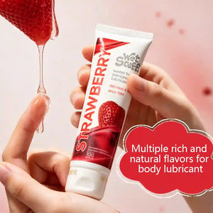 Tube of strawberry-flavored body 
fornication lubricant held by a hand with a red cloud text overlay.